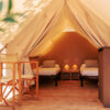 Glamping tent with cozy interior on a sunny day. Luxury camping tent for outdoor summer holiday and vacation lifestyle concept Преспа Ритрит - Резервација за Сафари Шатор